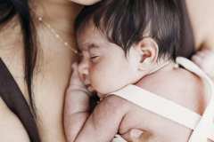 A newborn baby sleeps soundly on her mother's chest at a studio in Rockhampton.