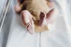A newborn baby's toes stretch out as it lies in a clear bassinet in the Rockhampton hospital.