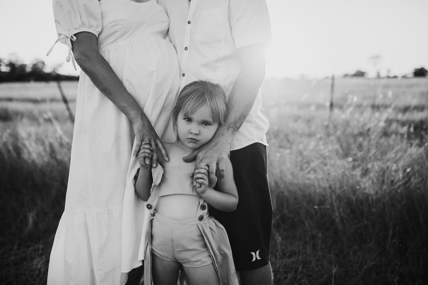 Murphy family A black and white image of a young girl holding her parents' hands