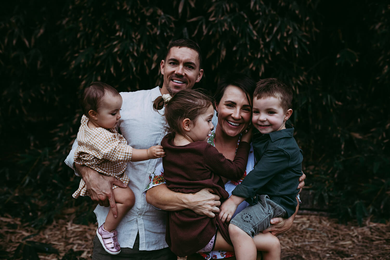 Murphy family A family of five cuddle with one another.