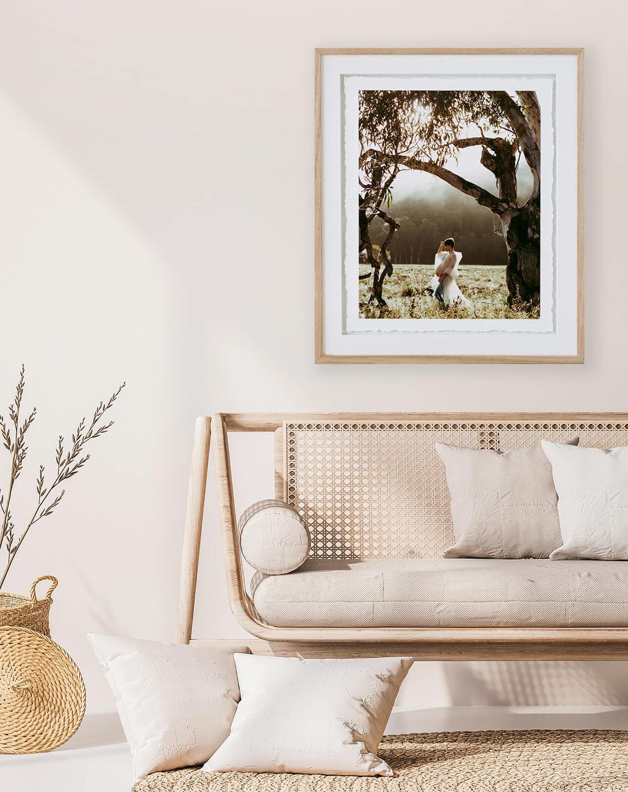 Close up for modern living room interior with natural wooden fur A photo is framed of a pregnant woman hangs above a brown couch.