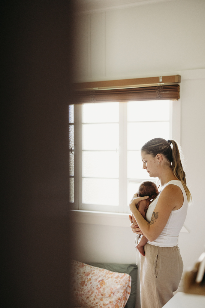 A mother holds her newborn baby.