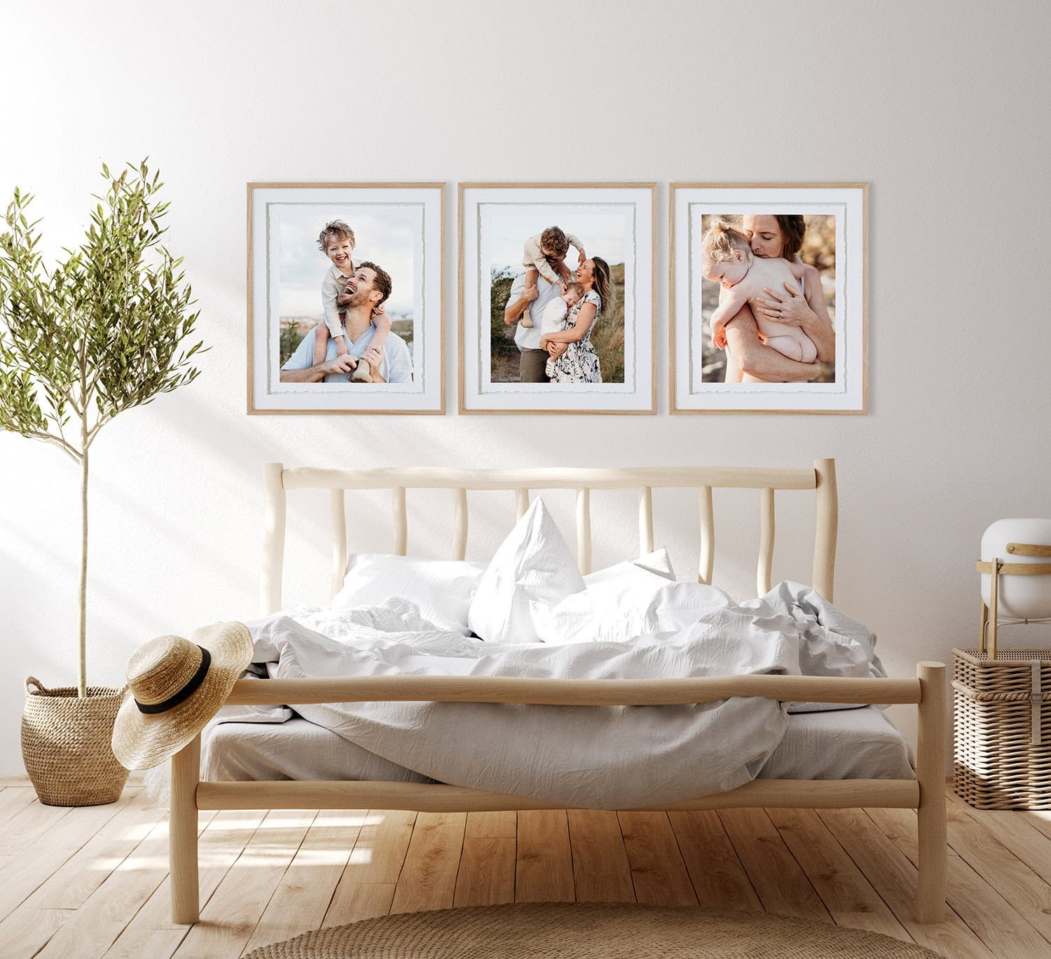 Preserving memories of your family in fine art frames Three fine art frames hang above a bed. The portraits are of a young family.