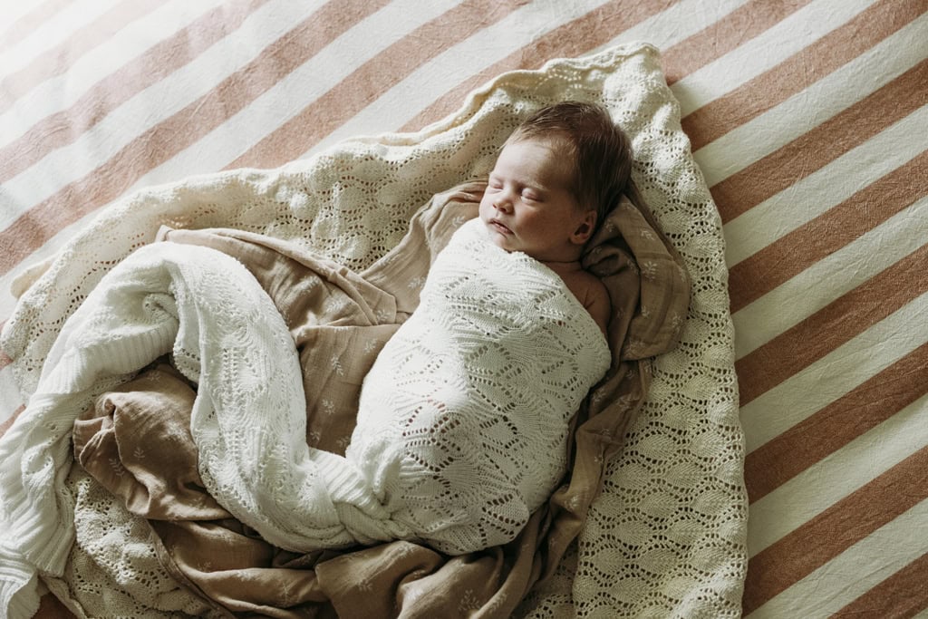 A newborn baby is wrapped in a blanket asleep at her home in Rockhampton.