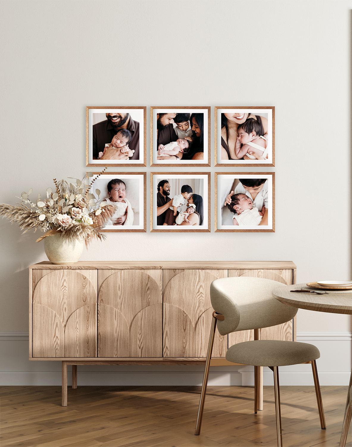 A set of six frames hangs above a sideboard in a dining room with newborn portraits in them.