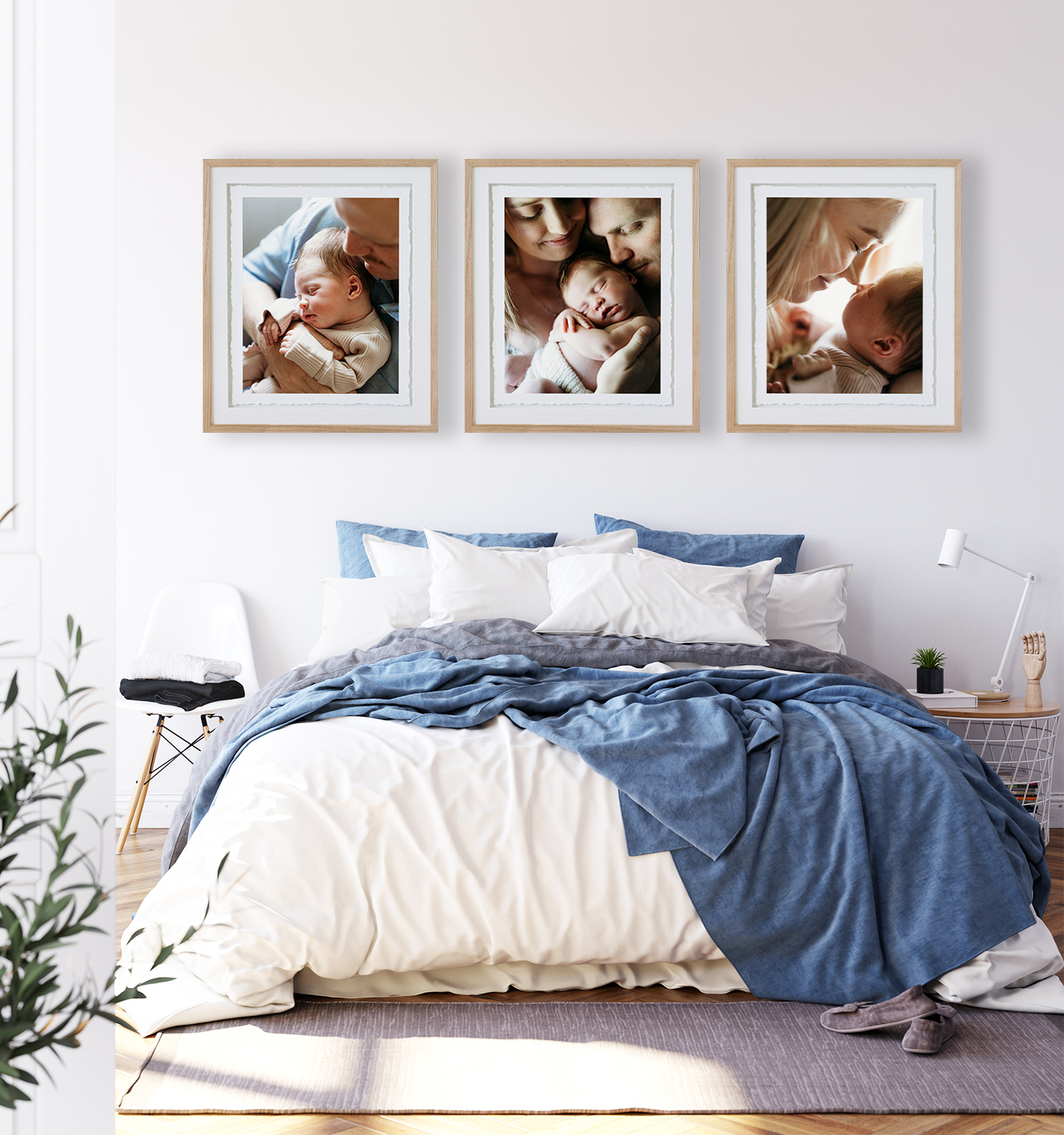 A set of three frames hangs above a bed with photos of a newborn baby and his mum and dad at their home in Rockhampton.