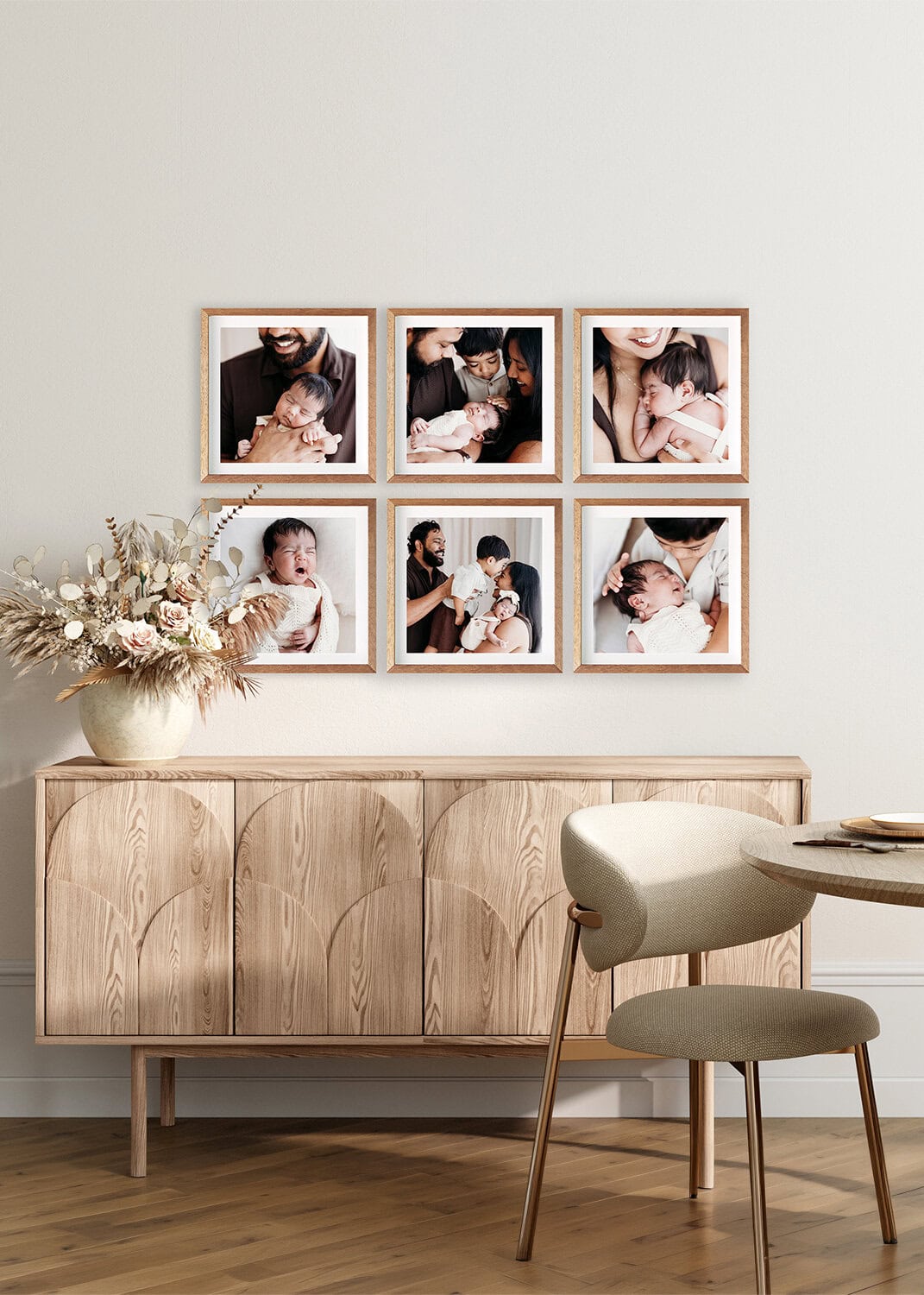 A set of six frames hangs above a sideboard with portraits of a family from their studio newborn session in Rockhampton.